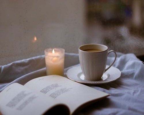 A warm, softly lit room during the rainy season in Mexico with a cup of coffee